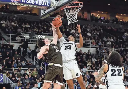  ?? ERIC CANHA/USA TODAY SPORTS ?? Friars forward Bryce Hopkins (23), who finished with his third double-double of the season with 25 points and 14 rebounds, tries to block a shot by Mountain Hawks forward Dominic Parolin during the second half of Friday night’s game at Amica Mutual Pavilion.