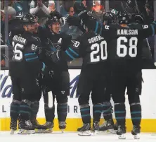  ?? Ben Margot / Associated Press ?? The Sharks’ Timo Meier (second from left) celebrates his game-winning goal with teammates Saturday night in San Jose.