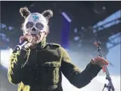  ??  ?? CAFÉ TACVBA lead singer Rubén Albarrán dons a mask for his band’s set during the one-day festival.