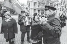  ?? VIKTOR DRACHEV, AFP/GETTY IMAGES ?? A man plays an accordion in Sevastopol on Monday as people celebrate Crimea’s vote for secession from Ukraine.