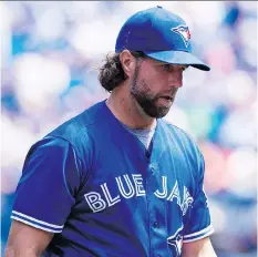  ?? AARON VINCENT ELKAIM/THE CANADIAN PRESS ?? Blue Jays pitcher R.A. Dickey walks off the field Wednesday during an 8-4 loss to the San Diego Padres in Toronto. Dickey allowed two home runs in taking the loss.