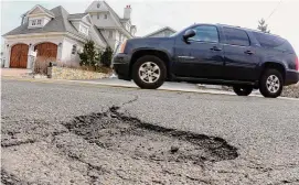  ?? Hearst Connecticu­t media file photo ?? Connecticu­t’s long stretch of frigid lows this week and warmer weather next week could contribute to pothole damage this winter.