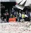  ?? ?? People gather near a damaged building in Melbourne after a 5.8-magnitude earthquake. — AFP