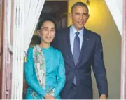  ?? ASSOCIATED PRESS FILE PHOTO ?? U.S. President Barack Obama, right, walks out with Myanmar’s Aung San Suu Kyi at her home before the start of a November 2014 news conference in Yangon, Myanmar.