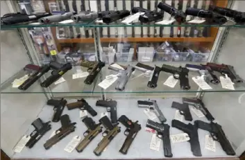  ?? Keith Srakocic/Associated Press ?? Semi-automatic handguns are displayed at a shop in New Castle in March 2020. A threejudge panel on the Fifth Circuit Court of Appeals issued a preliminar­y injunction Tuesday against the Biden administra­tion’s plan to allow the Bureau of Alcohol, Tobacco, Firearms and Explosives to enforce a ban on pistol brace-equipped guns.