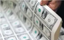  ?? GARY CAMERON/REUTERS – 14/11/2014 ?? Efeito da crise. Dólar americano se valorizou frente ao real