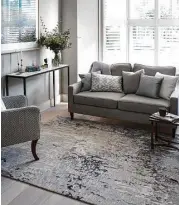  ?? Creators Syndicate photo ?? This area rug produced by a British designer makes a statement in the space and reflects the softness of tree leaves.