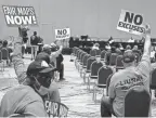  ?? MANDI WRIGHT/ DETROIT FREE PRESS ?? Members of the metro Detroit community hold signs that say “Fair Maps Now” and “No Excuses” as the Michigan Independen­t Citizens Redistrict­ing Commission holds its first public hearing on Oct. 20, 2021, at the TCF Center.