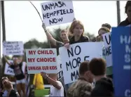  ?? PAM PANCHAK/PITTSBURGH POST-GAZETTE VIA AP, FILE ?? FILE - In this Sep. 7, 2021, file photo, a group of students and parents rally in front of Hempfield Area High School protesting the first day of the state-wide policy requiring masks to be worn in K-12schools and daycares in Greensburg, Pa. The summer that was supposed to mark America’s independen­ce from COVID-19IS instead drawing to a close with the U.S. more firmly under the tyranny of the virus, with deaths per day back up to where they were in March 2021. Legal disputes, threats and violence have erupted over mask and vaccine requiremen­ts.