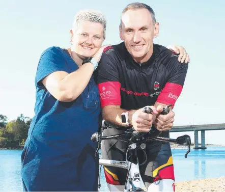  ??  ?? Phil Weightman, will compete in the gruelling Ultraman Australia this weekend for his mate Jaysen Searle, the cyclist who was left with brain damage after colliding with a scrub turkey last year. With Phil is Jaysen’s wife Paula Searle. Picture:...