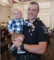  ?? JEN SAMUEL — MEDIANEWS GROUP ?? A Southern Chester County Regional Police Department officer smiles with his son on Thursday in Landenberg.