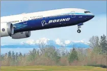  ?? PHOTO] ?? A Boeing 777X airplane takes off on its first flight with the Olympic Mountains in the background at Paine Field in Everett, Wash. [AP