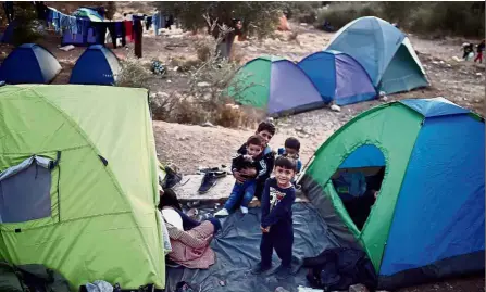  ?? — AFP ?? Pitiful conditions: Child refugees playing outside tents at the makeshift camp on Samos island.