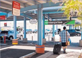  ?? MARLA BROSE/JOURNAL ?? A visitor heads out to find his rental car at the Sunport Car Rental Center.