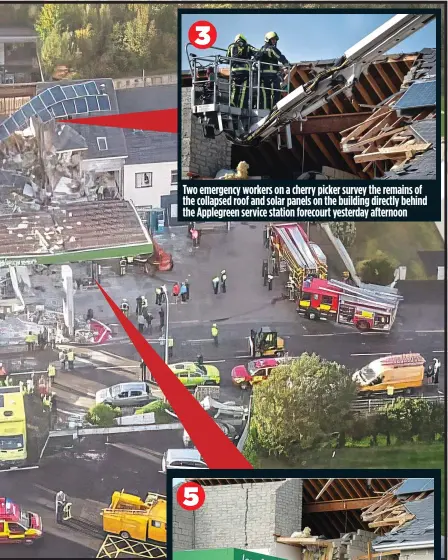  ?? ?? Two emergency workers on a cherry picker survey the remains of the collapsed roof and solar panels on the building directly behind the Applegreen service station forecourt yesterday afternoon
