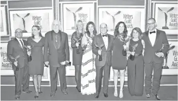  ?? — AFP file photo ?? (Left to right) Writers Jonathan Igla, Semi Chellas, Robert Towne, Janet Leahy, Carly Wray, Matthew Weiner, Erin Levy, Lisa Albert, and Tom Smuts, winners of the Drama Series award for ‘Mad Men’, pose during the 2016 Writers Guild Awards at in Los Angeles, California.