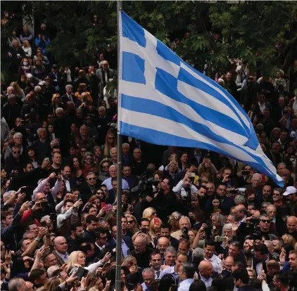  ?? Photo: AP/Thanassis Stavrakis. ?? Greece's Prime Minister and New Democracy leader Kyriakos Mitsotakis, center under the Greek flag, speaks to his supporters during his election campaign in northern Athens, Greece, Monday, May 1, 2023.