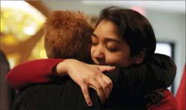  ?? THE ASSOCIATED PRESS ?? Nikita Deep, 16, embraces a family friend at Antigo United Methodist Church following a morning service Sunday in Antigo, Wis. According to police Jakob E. Wagner, 18, opened fire with a high-powered rifle outside of the a prom at Antigo High School...