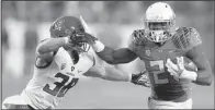  ?? AP/BEN MARGOT ?? Oregon running back Royce Freeman (right) fends off Arizona defender Jared Tevis during Friday’s Pac-12 Championsh­ip game at Levi’s Stadium in Santa Clara, Calif.