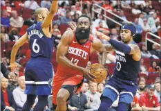  ?? Michael Wyke / Associated Press ?? Houston Rockets guard James Harden drives to the basket between Minnesota Timberwolv­es guard Jordans McLaughlin (6) and D’Angelo Russell during the second half of a game in March.