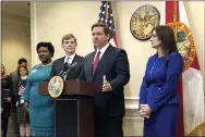  ?? BOBBY CAINA CALVAN — THE ASSOCIATED PRESS ?? Florida Gov. Ron DeSantis speaks during a news conference as Deputy Secretary for Health Dr. Shamarial Roberson, left, Florida Surgeon General Dr. Scott Rivkees, second from left, and Lt. Gov. Jeanette Nuñez, right, listen, Thursday in Tallahasse­e, Fla.