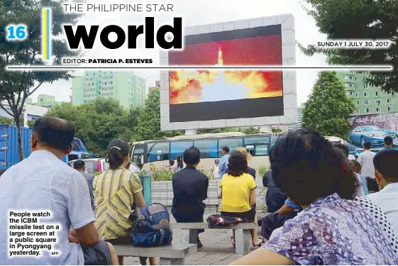  ?? AFP ?? People watch the ICBM missile test on a large screen at a public square in Pyongyang yesterday.