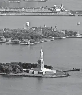 ?? MEL EVANS/AP ?? The Statue of Liberty National Monument and Ellis Island in New York are temporaril­y closed.