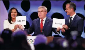  ?? LUIS CAMACHO/XINHUA ?? Internatio­nal Olympic Committee President Thomas Bach, center, poses for photos with Anne Hidalgo, left, Mayor of Paris, and Eric Garcetti, Mayor of Los Angeles, at the 131st IOC session in Lima, Peru, on Wednesday. The Internatio­nal Olympic Committee...