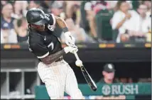  ?? ?? Chicago White Sox’s Tim Anderson hits an RBI double down the first base line off a pitch from Cleveland Guardians starting pitcher Cal Quantrill during the seventh inning of a baseball game in Chicago. Adam Engel scored
on the play. (AP)