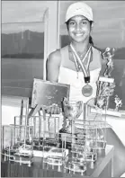  ??  ?? Adithya Karunaratn­e posing for a picture with the trophies she was awarded in California and Hong Kong.