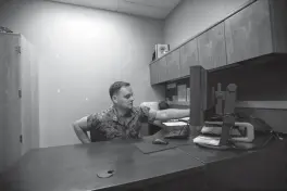  ?? Associated Press ?? ■ Marine Chief Warrant Officer David Coan, 35, works at his desk May 16 in Camp Pendleton, Calif. Coan has applied to be a part of a new cyber force after serving 17 years in the Marine Corps.