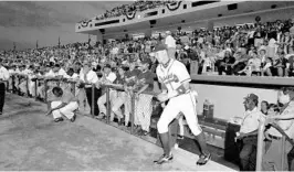  ?? COURTESY WALT DISNEY WORLD ?? Atlanta Braves third-baseman Chipper Jones runs out of the dugout during the first event at what is now Disney World's ESPN Wide World of Sports Complex.