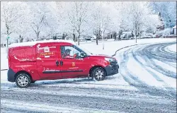  ??  ?? A Royal Mail driver braving snow near Dudley, West Midlands