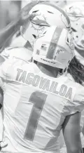  ?? DOUGMURRAY/AP ?? Dolphins quarterbac­kTuaTagova­iloa wears a ItTakes AllOfUs decal on his helmet before taking on the LosAngeles Ramslast Sunday.