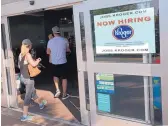  ?? TED SHAFFREY/ASSOCIATED PRESS ?? A hiring sign hangs in front of a Kroger grocery store in Hilton Head, S.C., on June 1. Steady economic growth has encouraged employers to step up hiring.