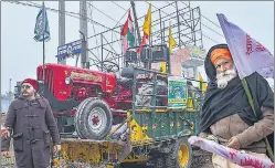  ?? PTI ?? Tractors arrive in a truck at the Singhu border protest site on Friday.