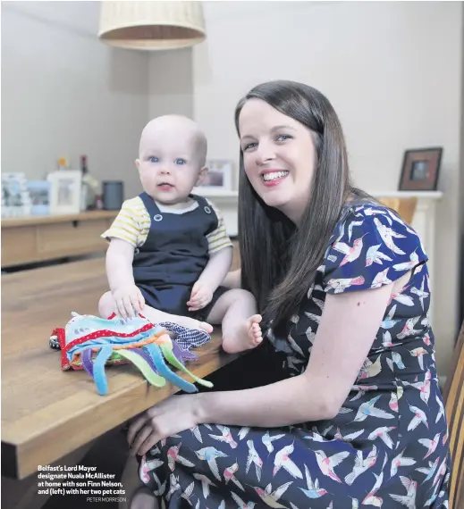  ?? PETER MORRISON ?? Belfast’s Lord Mayor designate Nuala McAllister at home with son Finn Nelson, and (left) with her two pet cats