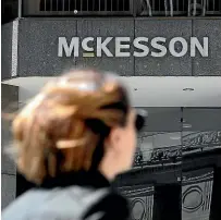  ?? AP, FILE ?? A pedestrian passes a Mckesson sign on an office building in San Francisco. A $26 billion settlement has been announced between the three biggest US drug distributi­on companies and drugmaker Johnson & Johnson and thousands of states and municipali­ties that sued over the toll of the opioid crisis.
