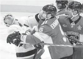  ?? ALIE SKOWRONSKI askowronsk­i@miamiheral­d.com ?? Panthers defenseman Oliver Ekman-Larsson punches Islanders right wing Cal Clutterbuc­k during a scuffle in the third period of Florida’s 3-2 loss Thursday in Sunrise. Ekman-Larsson was penalized for roughing. At right is Panthers’ defenseman Dmitry Kulikov.