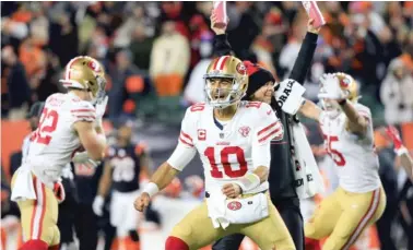  ?? GETTY IMAGES ?? Jimmy Garoppolo is fired up about his game-winning, 12-yard touchdown pass in overtime to beat the Bengals.