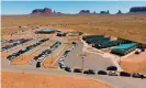  ?? Photograph: Mark Ralston/AFP/Getty Images ?? People line up in vehicles to collect water and supplies from a distributi­on point in Monument Valley at the Utah and Arizona border.