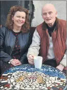  ?? John Ahern) (Pic: ?? BOWLED OVER: HSE Community Health Officer, Jacinta McCormack and chairman of Fermoy Resource Centre, Seamus Aherne, trying out one of the new mosaic coffee tables, which were unveiled recently at a ceremony in the centre. The table featured has the theme ‘Hands Holding A Bowl’, acknowledg­ing the centre’s role in proving a Meals On Wheels service. All 4 tables were created using recycled materials.