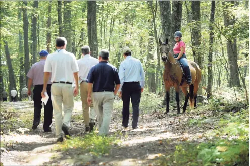  ?? Hearst Connecticu­t Media file photo ?? A horse and rider wait for a group from the state Siting Council, Ameresco New Milford officials during a 2017 walking tour of the area proposed for solar panels on Candlewood Mountain in New Milford. Companies planning to buy power from the proposed solar farn have canceled their agreements.