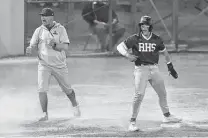  ?? ?? Reagan baseball coach Chans Chapman and Cole Tabor enjoy the big inning at Blossom Athletic Center.