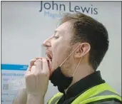  ?? ?? VITAL JOB: A John Lewis worker tests himself