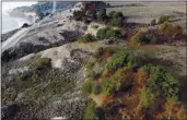  ?? JANE TYSKA — BAY AREA NEWS GROUP ?? Burn scars from the CZU August Lightning Complex fire are seen from this drone view along Highway 1 north of Davenport on Wednesday, Dec. 9. The wildfire burned inconsiste­ntly through the area in late August, leaving some areas untouched while others look like a moonscape.