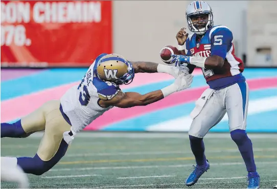  ?? ALLEN McINNIS ?? Alouettes QB Kevin Glenn has the ball stripped from his hands by Blue Bombers defensive lineman Justin Cole at Molson Stadium on Friday. Winnipeg won 32-18.