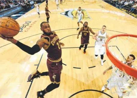  ?? John Leyba, The Denver Post ?? The Cleveland Cavaliers’ LeBron James soars to dunk for two of his 18 points Wednesday night.