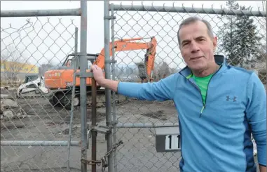  ?? GARY NYLANDER/The Daily Courier ?? Landowner Zeljko Gregov stands at the entrance gate to property where former stables built in 1906 were demolished this week to make way for widening and redevelopm­ent of Clement Avenue in Kelowna.