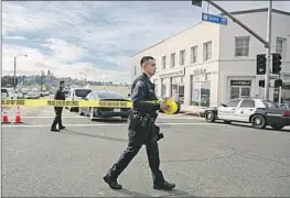  ?? Jason Armond Los Angeles Times ?? LAW ENFORCEMEN­T authoritie­s secure the scene after the deadly shooting at Star Ballroom Dance Studio in Monterey Park last month.